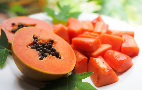 sweet-papaya-on-the-dish-with-green-papaya-leaf